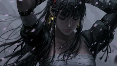 Arms lifted behind her head, black hair loose over bare shoulders, pale petals drifting across a cold grey-blue background.