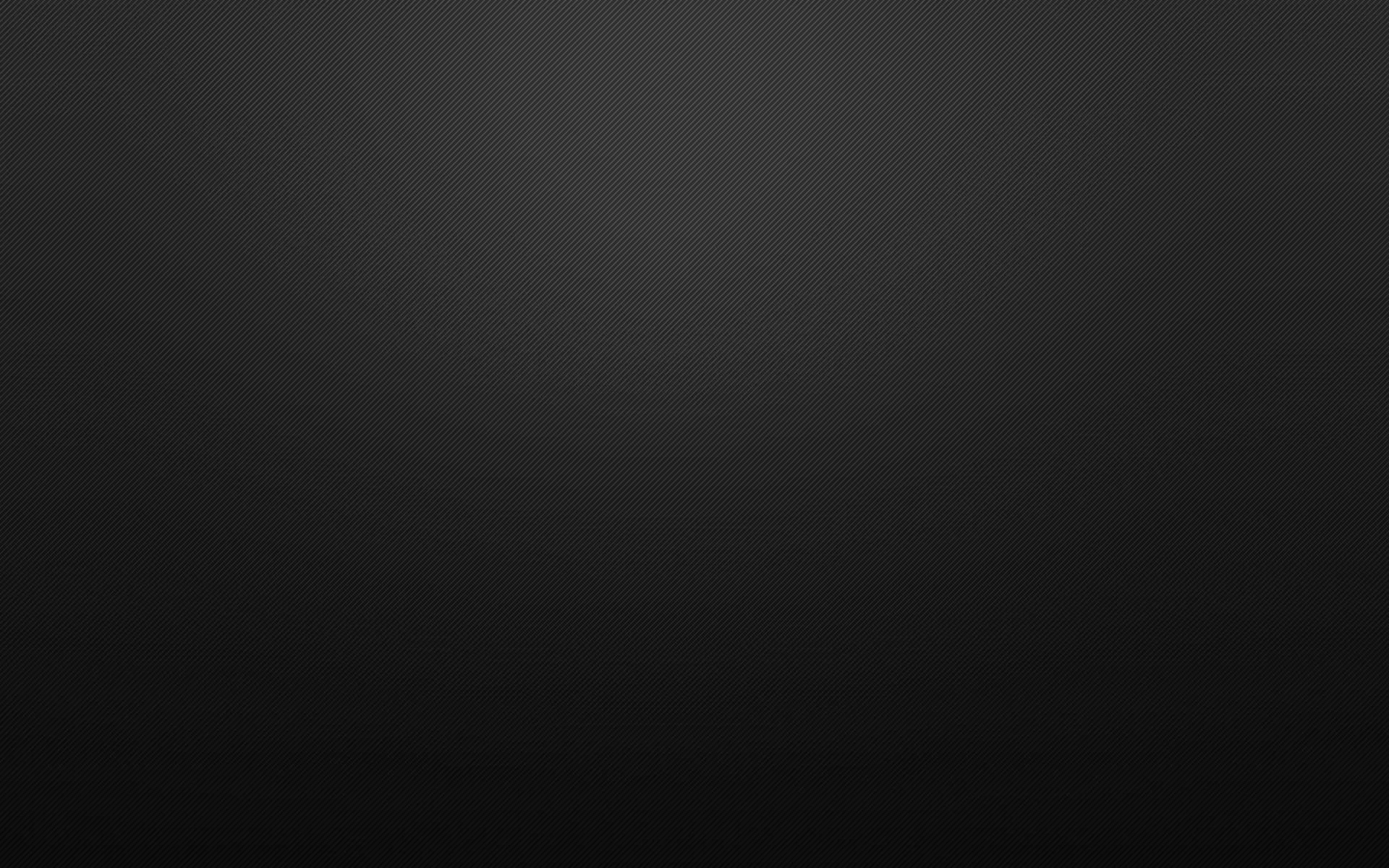 A soft grey glow sits high in the frame and falls away to black at every corner, leaving the middle clear for icons.
