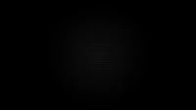 Almost the entire frame reads as flat black, with a dim round glow and a few horizontal ridges surfacing at the centre.