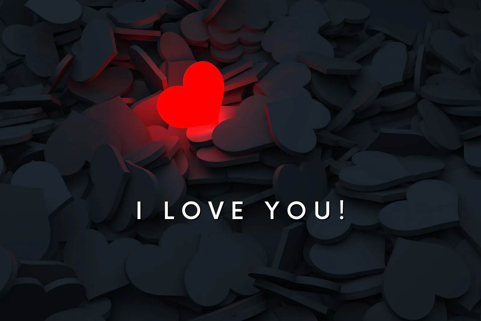 One red heart lights up from within a scattered pile of flat grey paper hearts, the words I LOVE YOU set below it in white.