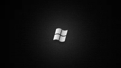 A glossy white window mark sits centred on a fine dark hexagonal mesh with even light throughout.