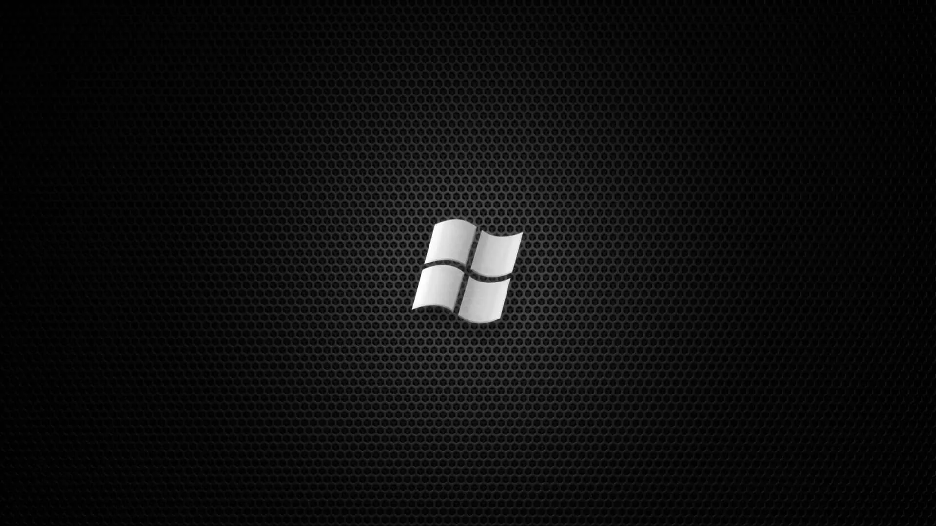 A glossy white window mark sits centred on a fine dark hexagonal mesh with even light throughout.