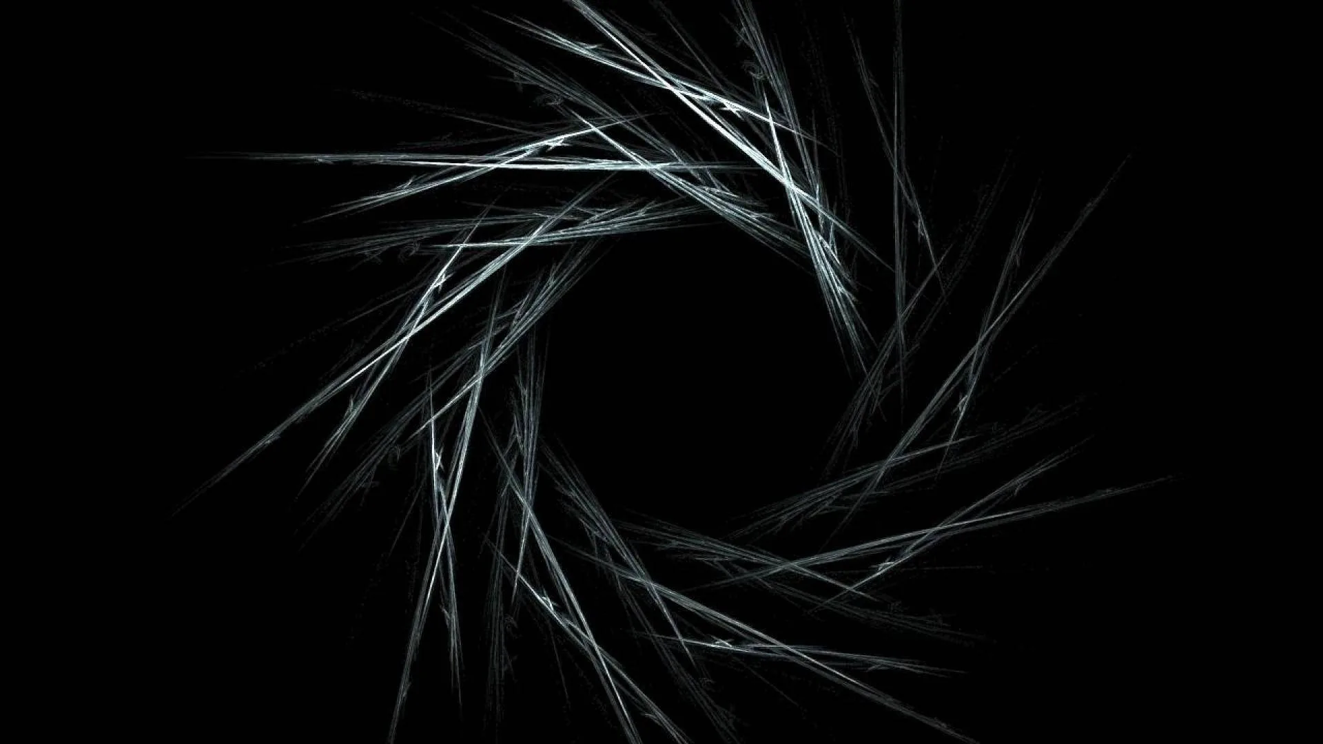 Fine white filaments curl into a broken ring at the centre of the frame, the middle left completely empty.