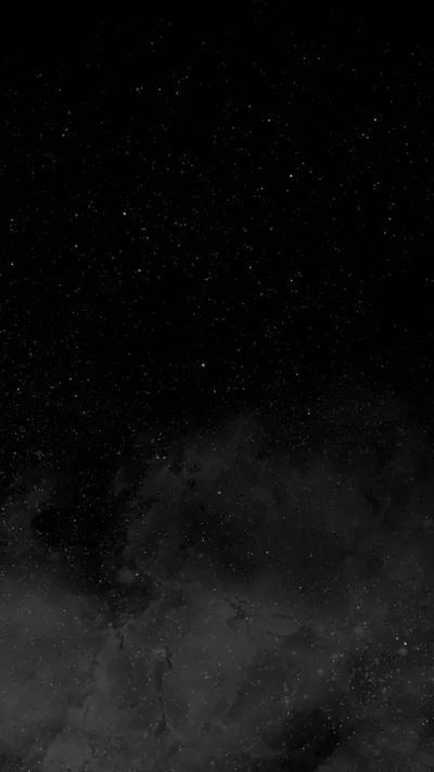 Pale smoke rolls up from the bottom of a tall frame while scattered white specks fill the black sky above it, the top corners left clear.