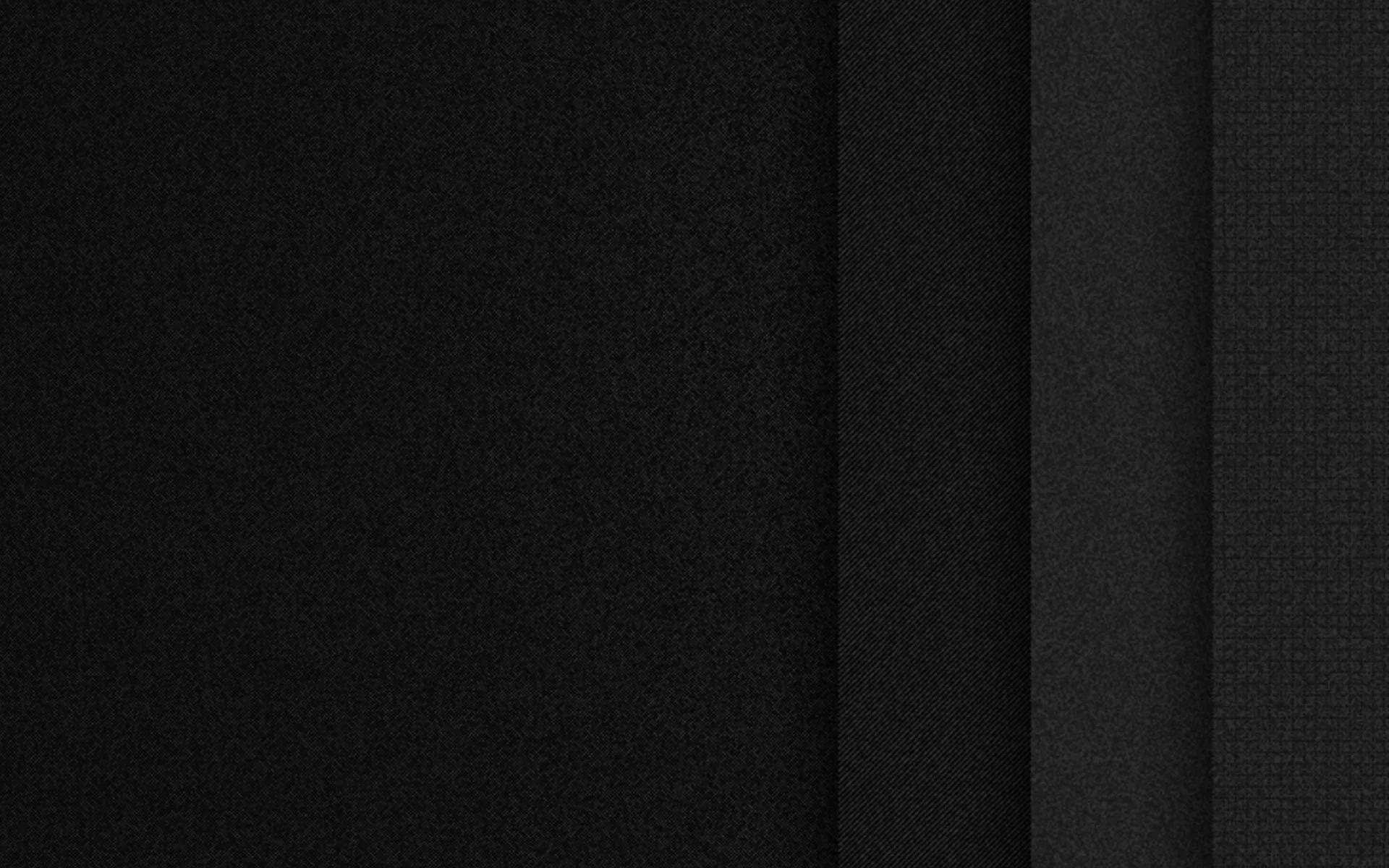 Layered fabric panels run side by side in charcoal and black, the seams between them catching just enough light to separate each layer.