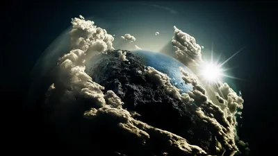 Sunlit thunderheads climb around the planet's curve like mountain ranges while a star flare breaks at the right edge, the corners falling off into black.