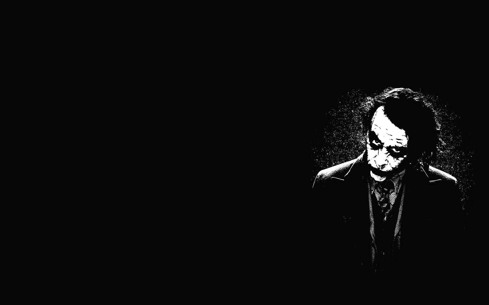 The Joker stands at the right in high-contrast monochrome, head lowered, the left two-thirds of the frame empty.