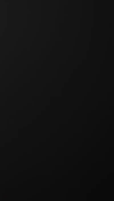 An unbroken black gradient down a tall frame, a faint sheen sliding across the upper left corner and nothing else to compete with app icons.