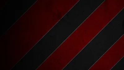 Wide diagonal bands of red and black run corner to corner, scuffed with grunge marks that show up strongest on the red.