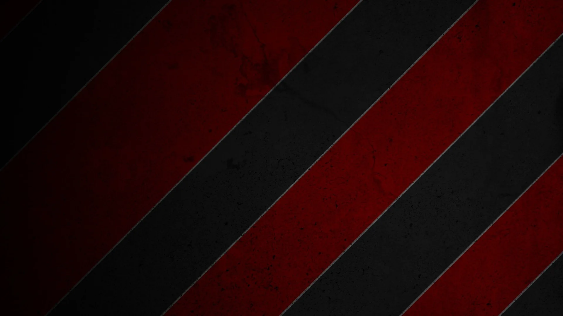 Wide diagonal bands of red and black run corner to corner, scuffed with grunge marks that show up strongest on the red.
