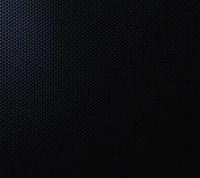 A honeycomb of punched holes fills the frame, cool blue light spilling in from the top left and the lower right lost to shadow.