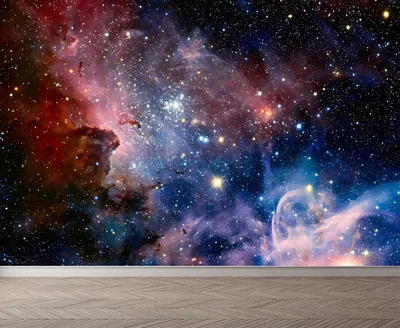 A star-filled nebula in red and blue shown as a wall mural mockup, wooden floor in the foreground giving the room scale.