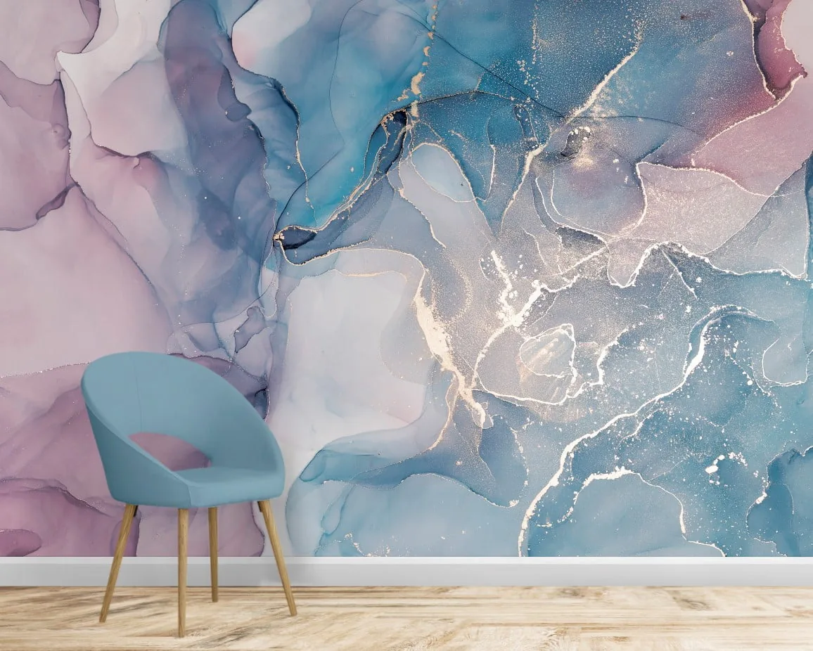 A room-scale mural of pink and blue alcohol ink veined with gold, shown behind a teal chair on a light wood floor.