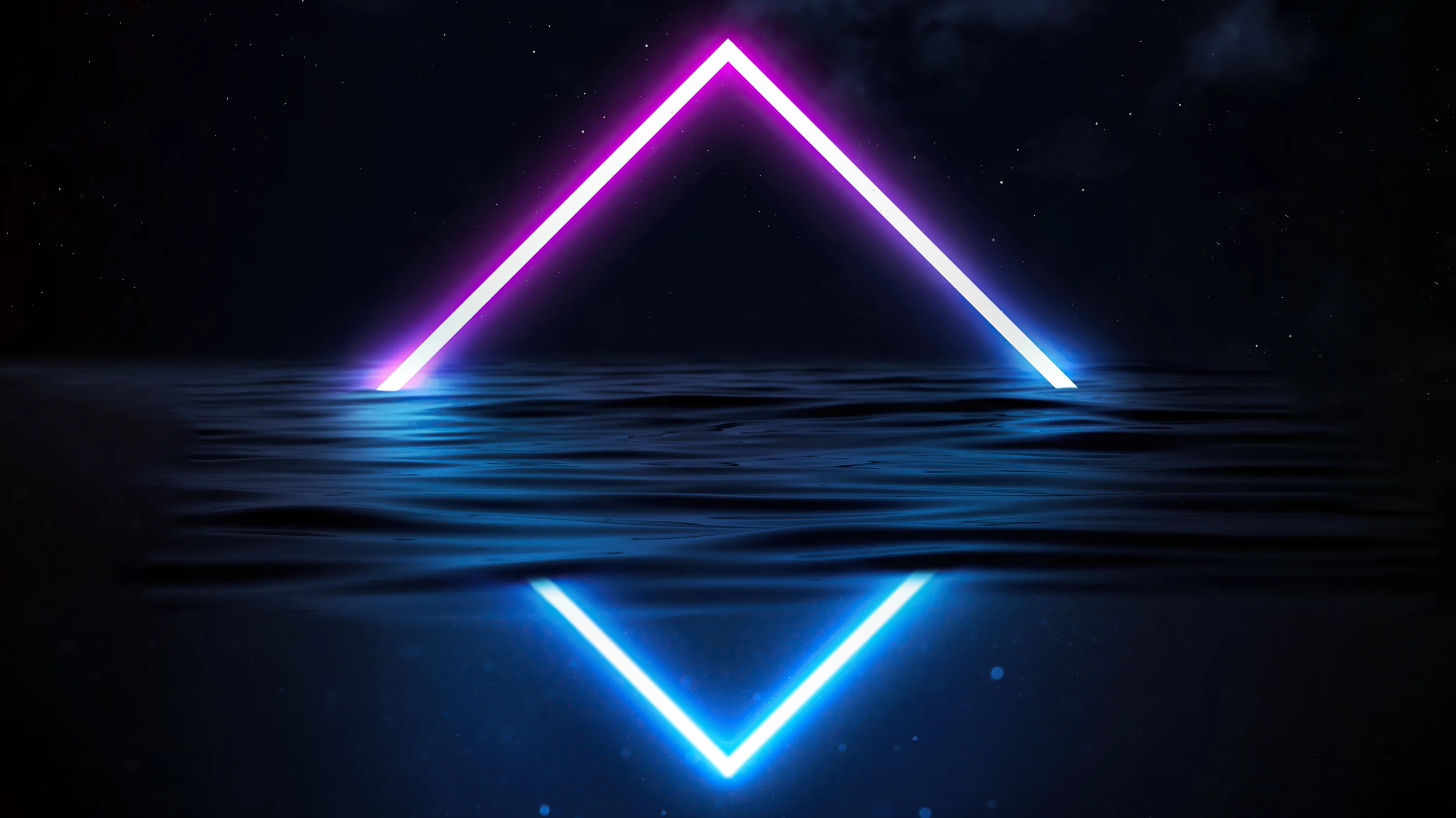 A pink and blue triangle floats above still water at night, its mirrored half rippling in the surface below.