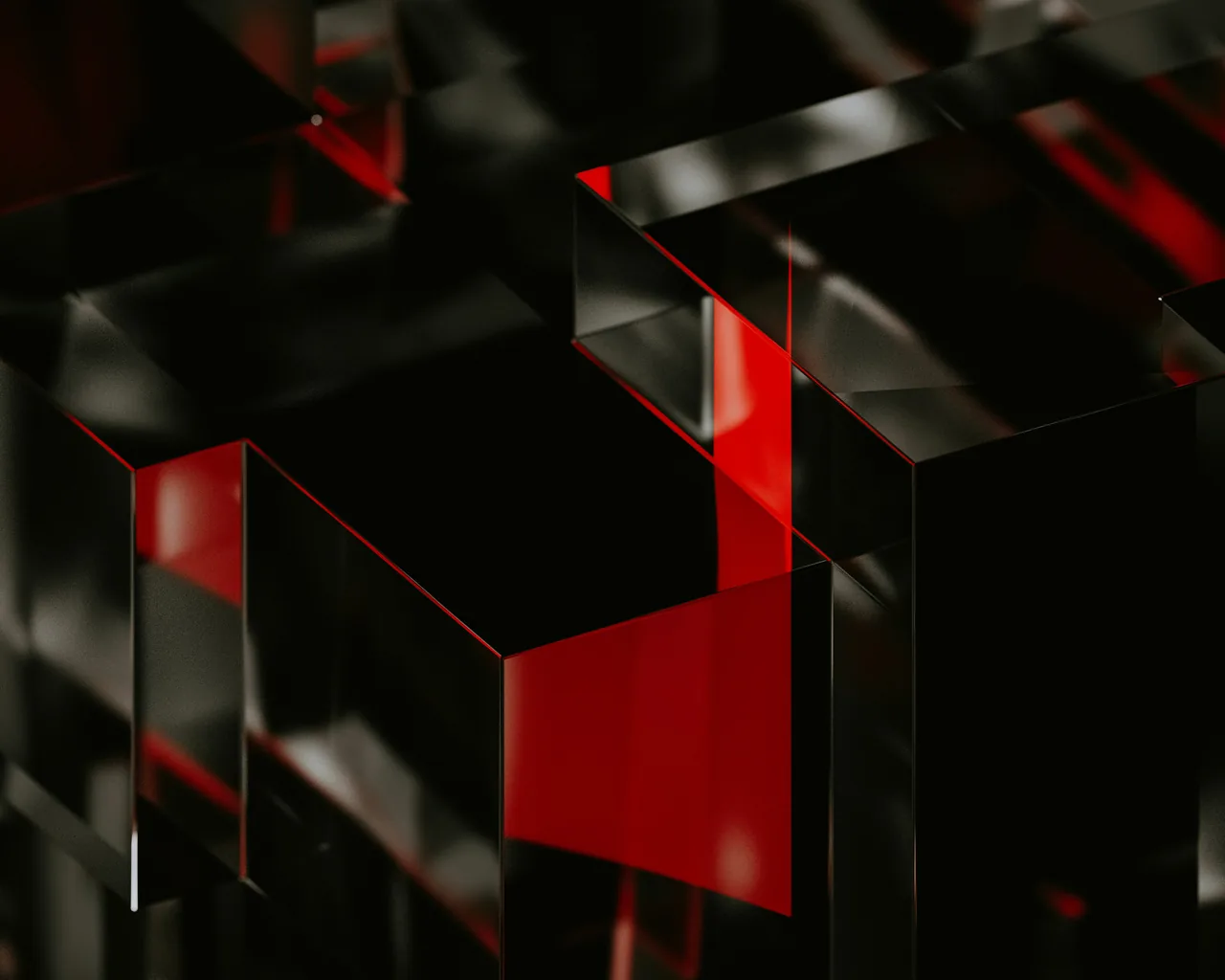 Translucent 3D blocks stack at sharp angles, red panels glowing between black glass faces, with the strongest light landing just right of centre.