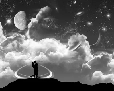 A greyscale scene of two figures embracing on a dark ridge while ringed planets, spiral galaxies and towering clouds fill the sky behind them.