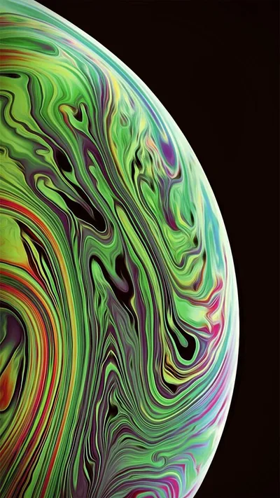 A sphere marbled in green, yellow and threads of red bulges in from the left, the top right corner staying true black for AMOLED panels.
