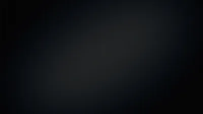 A soft band of cool light crosses in from the lower left, everything around it settling into near-black.