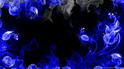 Rose shapes formed from blue and white smoke ring the edges of the frame, leaving a wide black hollow open through the middle.