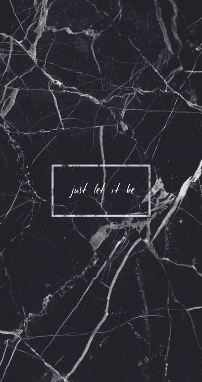 Pale veins run through polished black marble, a small handwritten line boxed off at the centre of the frame.