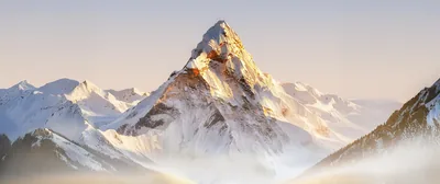 An ultrawide render of a pale mountain lit from the right, its lower slopes dissolving into cream-coloured mist on both sides.