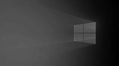 A pale window outline stands against a grey wall with light beams stretching away to the left.