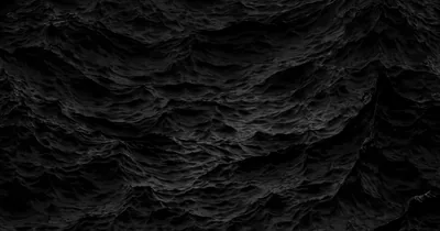 Jagged rock covers the whole frame in near-uniform black, the relief showing only where the light grazes it.