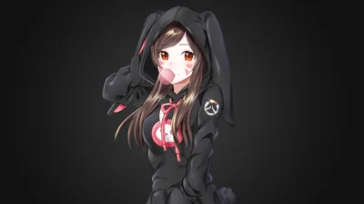 A brown-haired girl blows a pink bubble inside an oversized black bunny hoodie, ears flopping, lit softly against a smooth charcoal gradient.