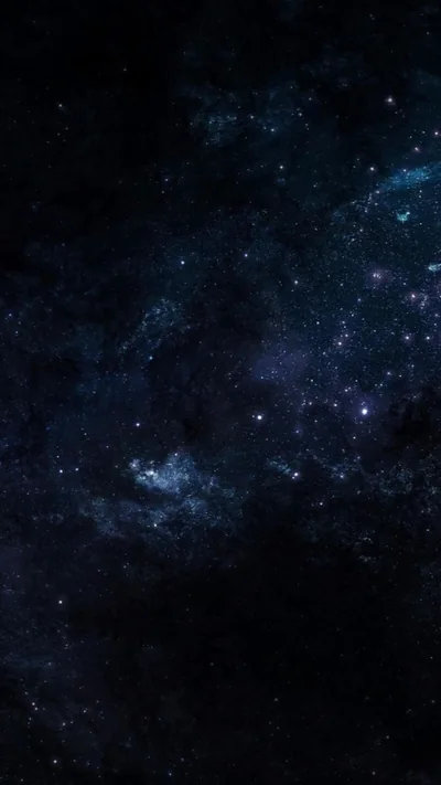 Thousands of pinprick stars scatter across a blue-black sky, a faint dust cloud drifting through the lower half.