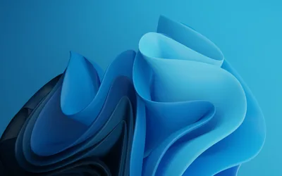 Sheets of light blue curl and fold into a soft peak on the right, a darker slab tucked behind them against a plain blue field.