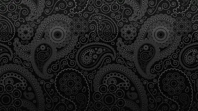 Hand-drawn paisley teardrops and dotted rings pack the frame in ash grey, boldest through the centre band, both lower corners easing back into shadow.