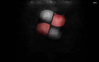 The four-pane mark sits large on a scratched dark wall, two panes red and two brushed grey.