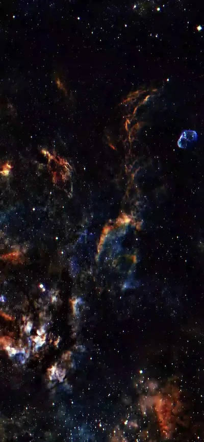 Amber gas glows along the lower left while teal wisps and a small blue shell sit higher up, the whole column packed with stars.