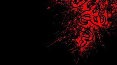 Thick red ink explodes from the upper right corner, flinging droplets and torn tribal shapes across an otherwise black frame.
