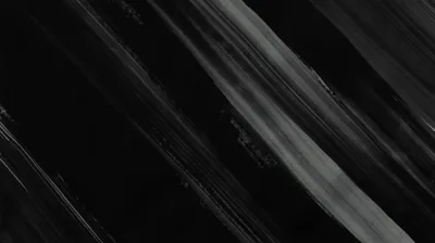 Wide brush strokes cut across the frame at an angle, grey pigment dragging through wet black paint.