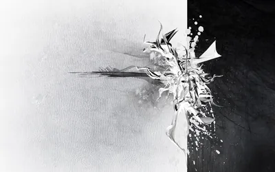 The frame splits down the middle, textured white on the left and deep black on the right, with a spike of shattered fragments blowing out where the two meet.