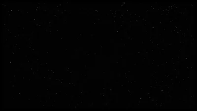Tiny pinpoint stars scatter thinly across an almost pure black frame, slightly denser along the right edge, leaving the centre flat black for OLED screens and readable icons.