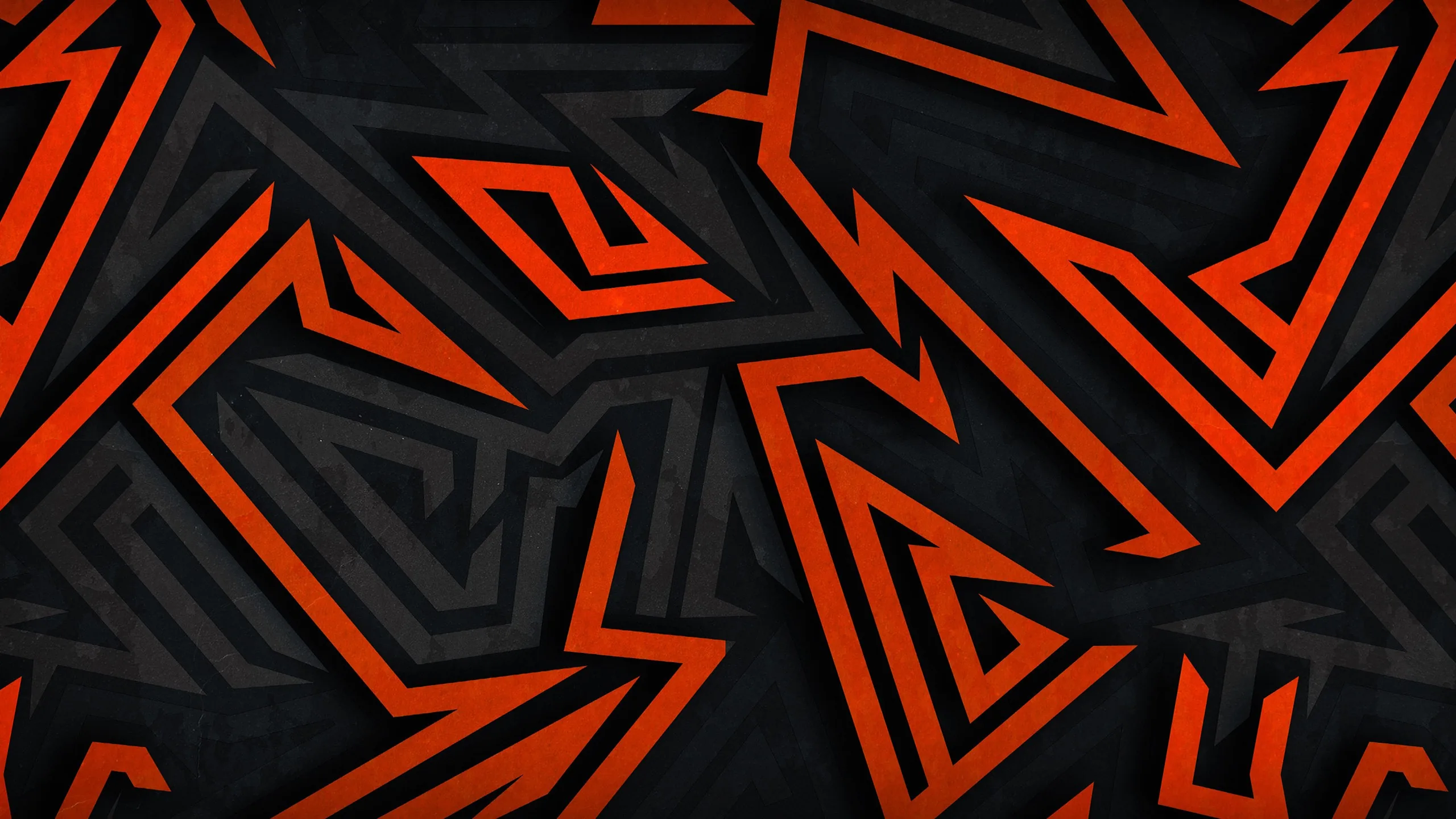 Interlocking arrowheads and maze lines in burnt orange sit on charcoal panels, the pattern repeating right across the frame with no centre.