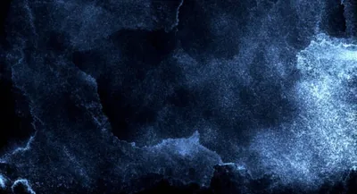 A watercolor wash of charcoal navy with pale spray blooming along the lower edge and right side, the top left staying closest to solid black.
