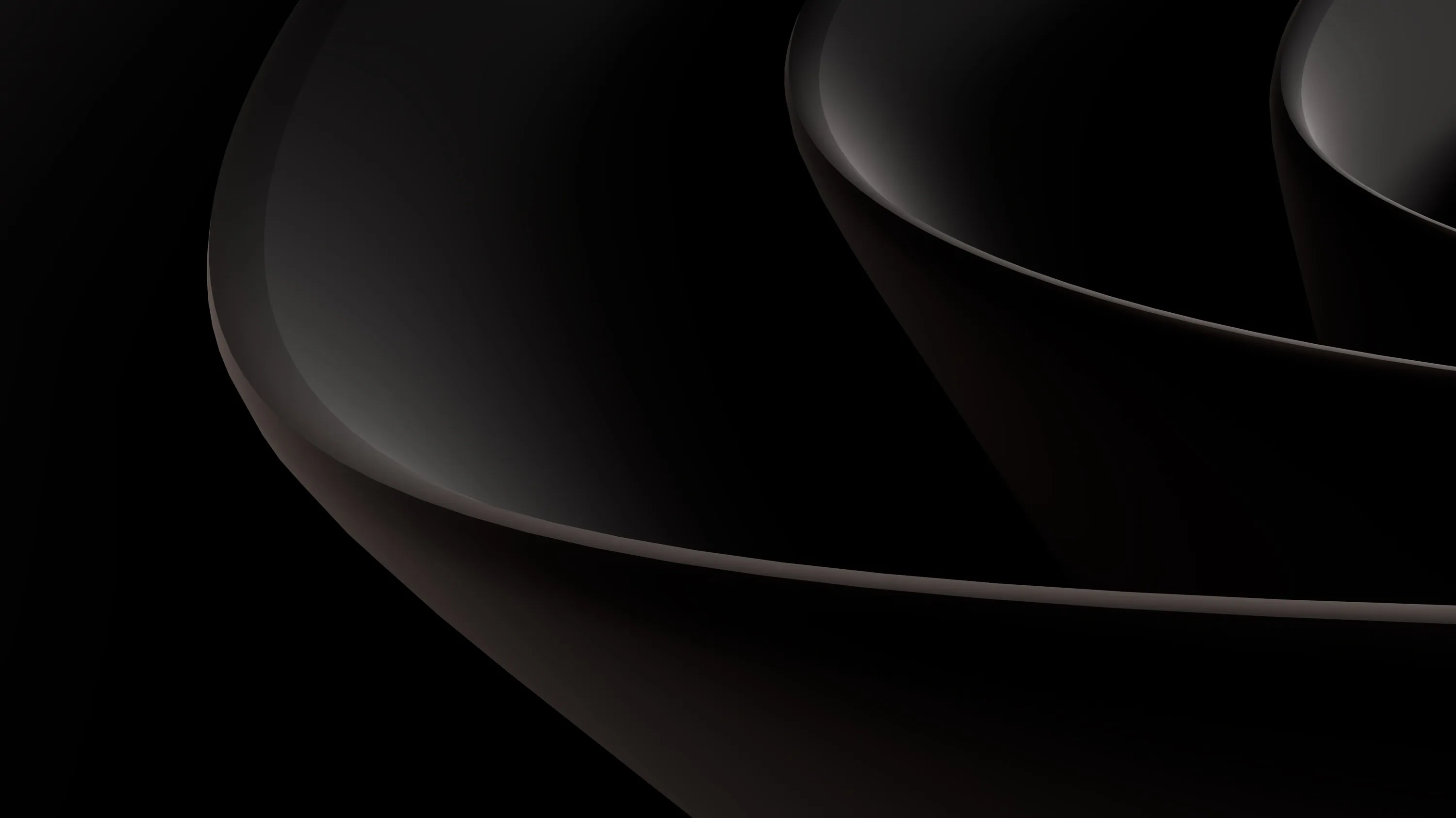 Two large curved surfaces nest into one another in dark brown-black, their rims catching a thin highlight from the right.