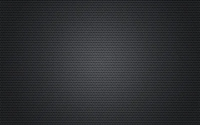 Thousands of tiny punched holes cover a dark grille, a faint glow lifting the centre while a soft vignette pulls every corner toward black.