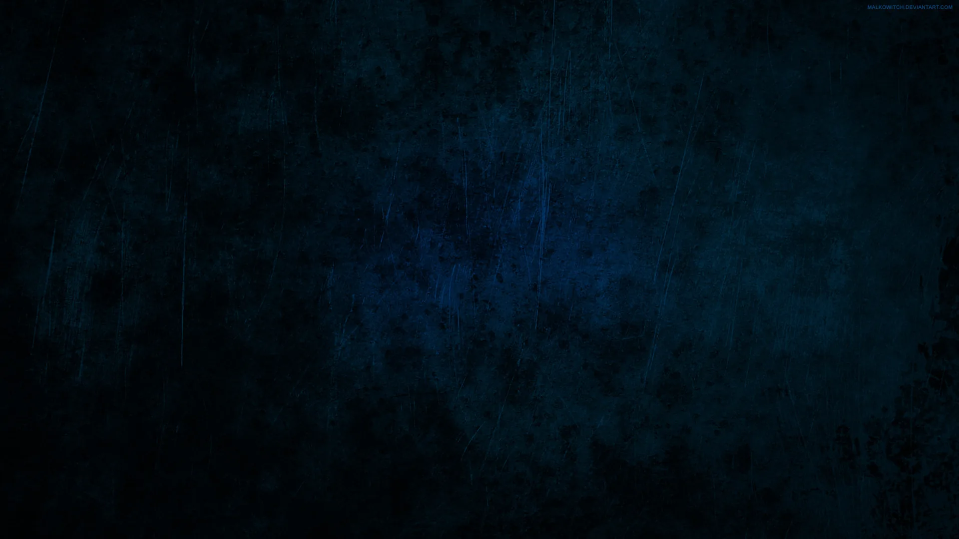 A worn navy surface covered in scratches and blotches, faintly lit toward the upper left and sinking to near-black around every border.