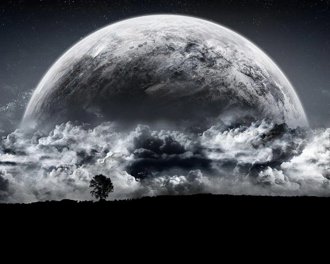 A huge moon dome climbs from behind a bank of grey storm clouds, one bare tree on the black ridge below, the whole scene in monochrome.