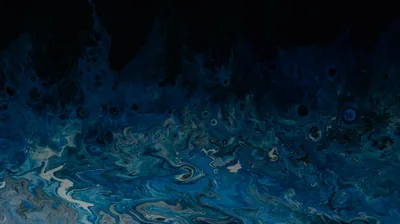 Poured acrylic in navy and teal swirls along the bottom half of the frame, the paint thinning into deep black toward the top edge.