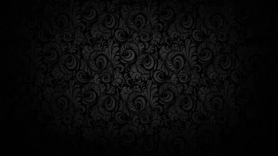 A dense baroque scroll pattern in charcoal on black, brightest through the middle band.
