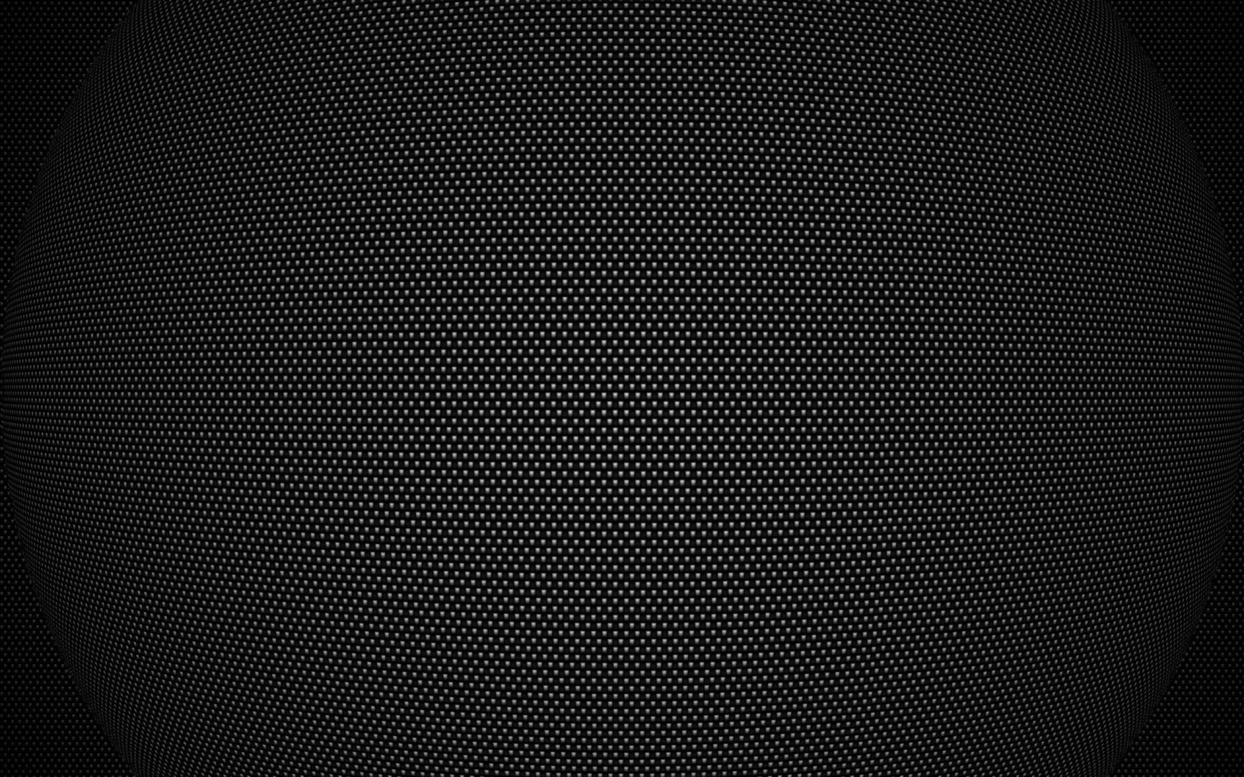 An even field of tiny holes covers a dark metal sheet, brightest through the middle band and dimming toward all four corners.