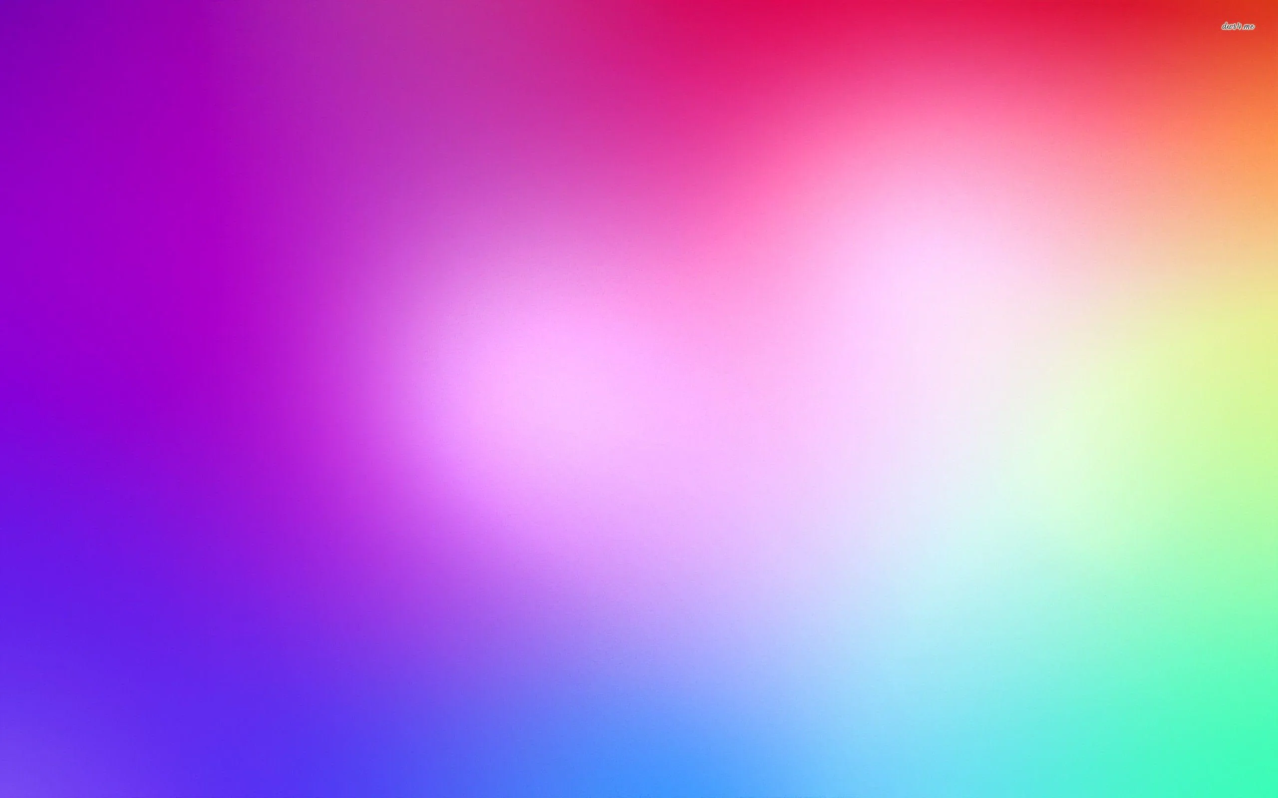 Purple, hot pink, green and cyan blur together around a bright white heart of light just left of centre, every hue running at full saturation.