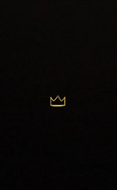 A tiny gold crown outline sits just below centre on an otherwise empty black field — plenty of room left for the clock and icons.