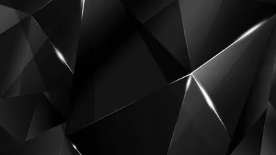 Large angular facets in near-black, each edge catching a thin silver highlight, with the brightest split running down the right side.
