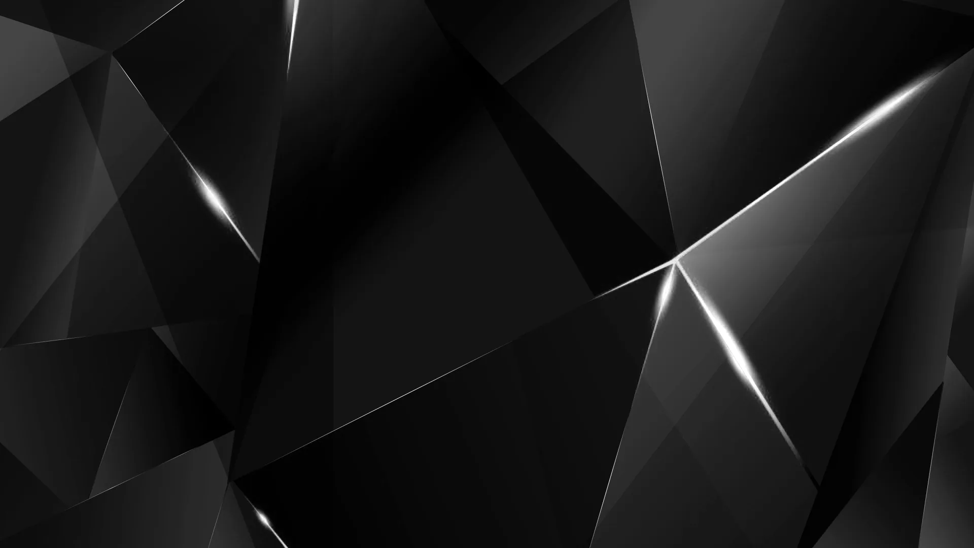 Large angular facets in near-black, each edge catching a thin silver highlight, with the brightest split running down the right side.